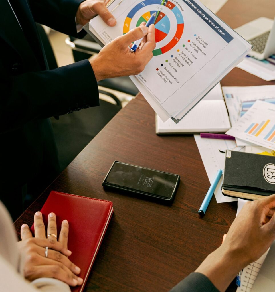 Business professionals discussing financial charts during a strategy meeting.